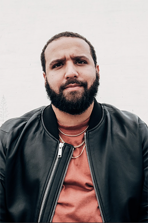 Photo of Wesley Lowery in a red shirt and black jacket.