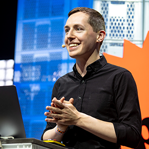 Photo of Paris Marx standing at a podium making a presentation.