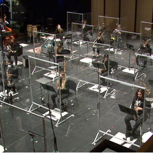 Western University Jazz Ensemble performing on stage behind barriers