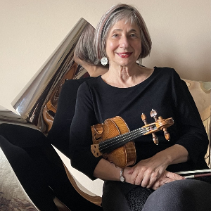 Mimi Zweig holding a violin