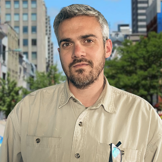 A photograph of Ryan Craven with a backdrop of Dundas Place in downtown London