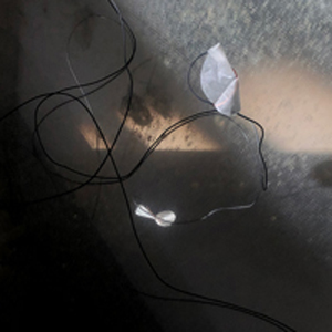 wires and a speaker on cement floor